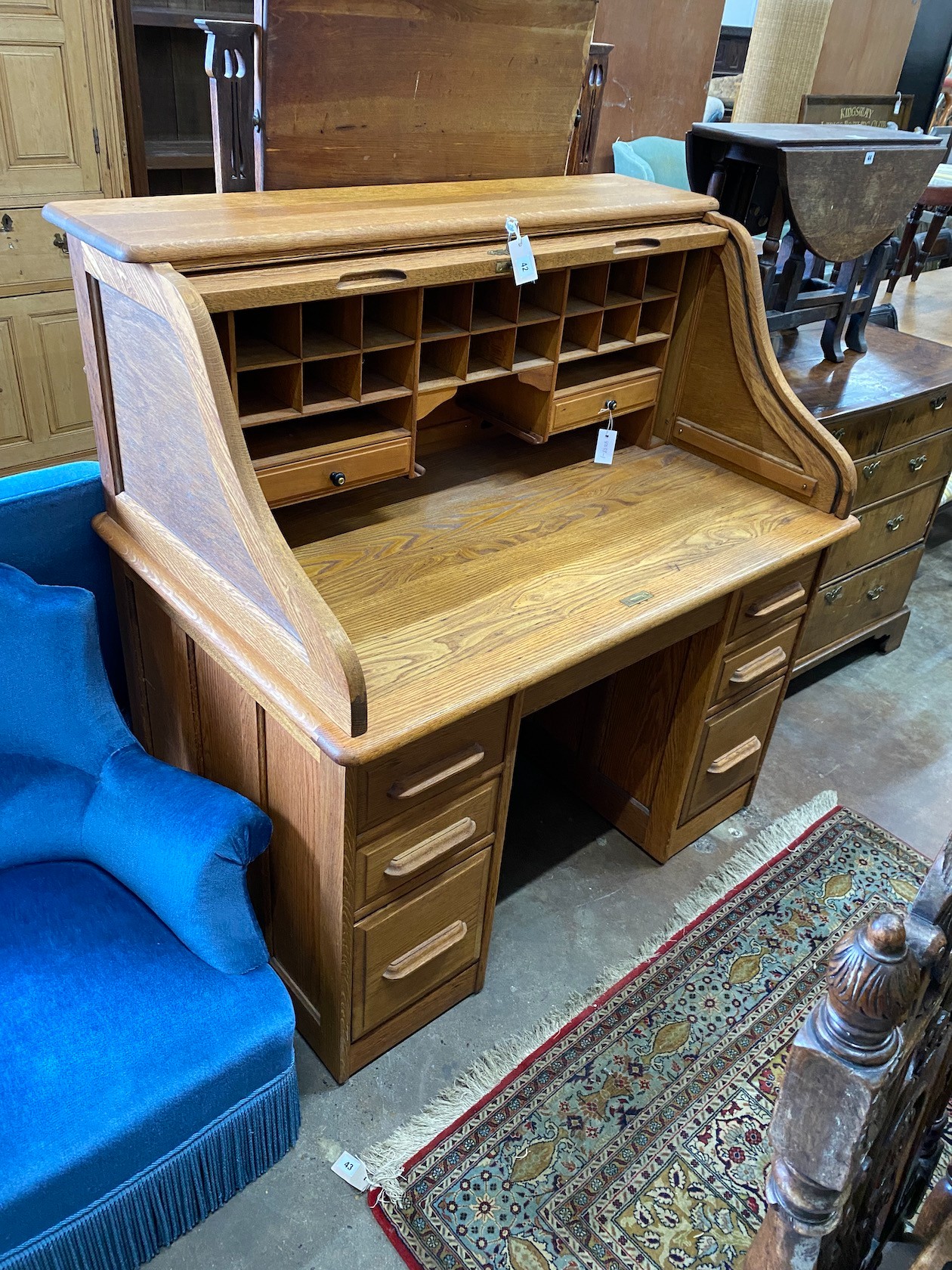 An early 20th century pale oak roll top desk, with 'S' shape tambour, width 121cm, depth 77cm, height 127cm